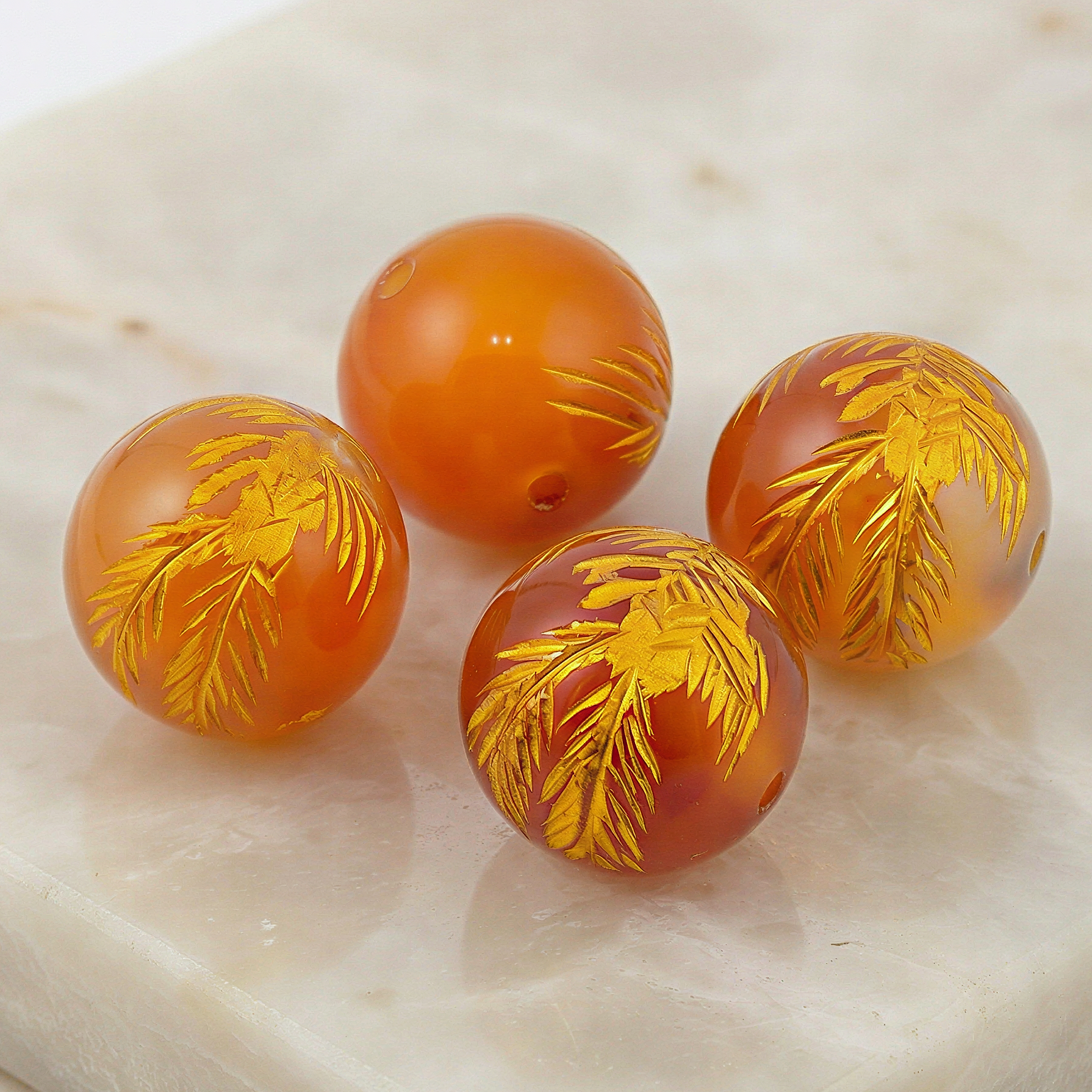 Polished carnelian phoenix carved 12mm round bead showcased with refined clarity, warm tones, and subtle natural texture