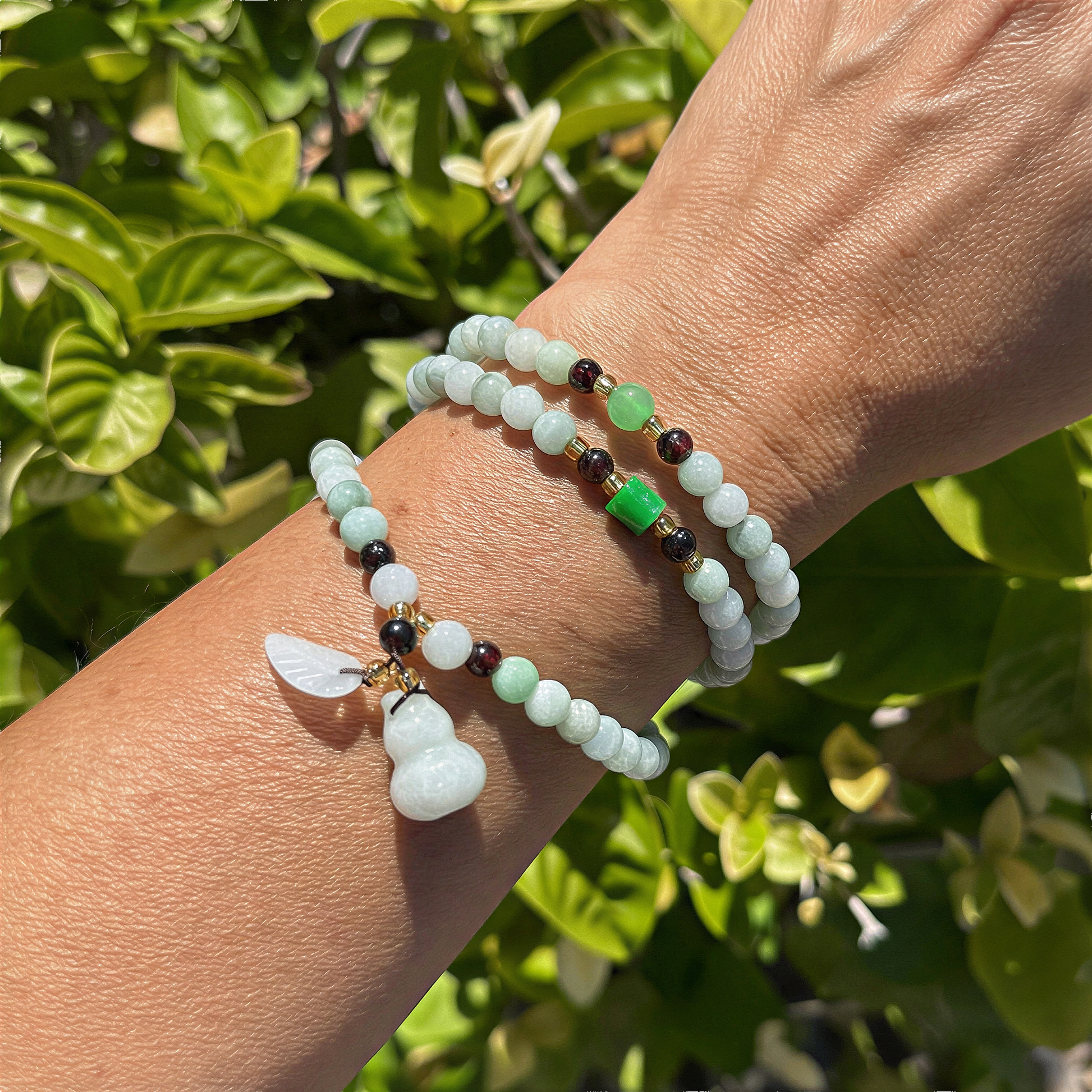 Jade 6mm round triple wrap stretchy cord necklace with prosperity charms, softly lit for refined clarity and natural color