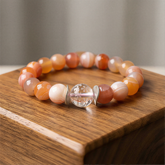 Cherry blossom stretchy bracelet kit with pastel beads neatly arranged on neutral surface under soft, refined lighting