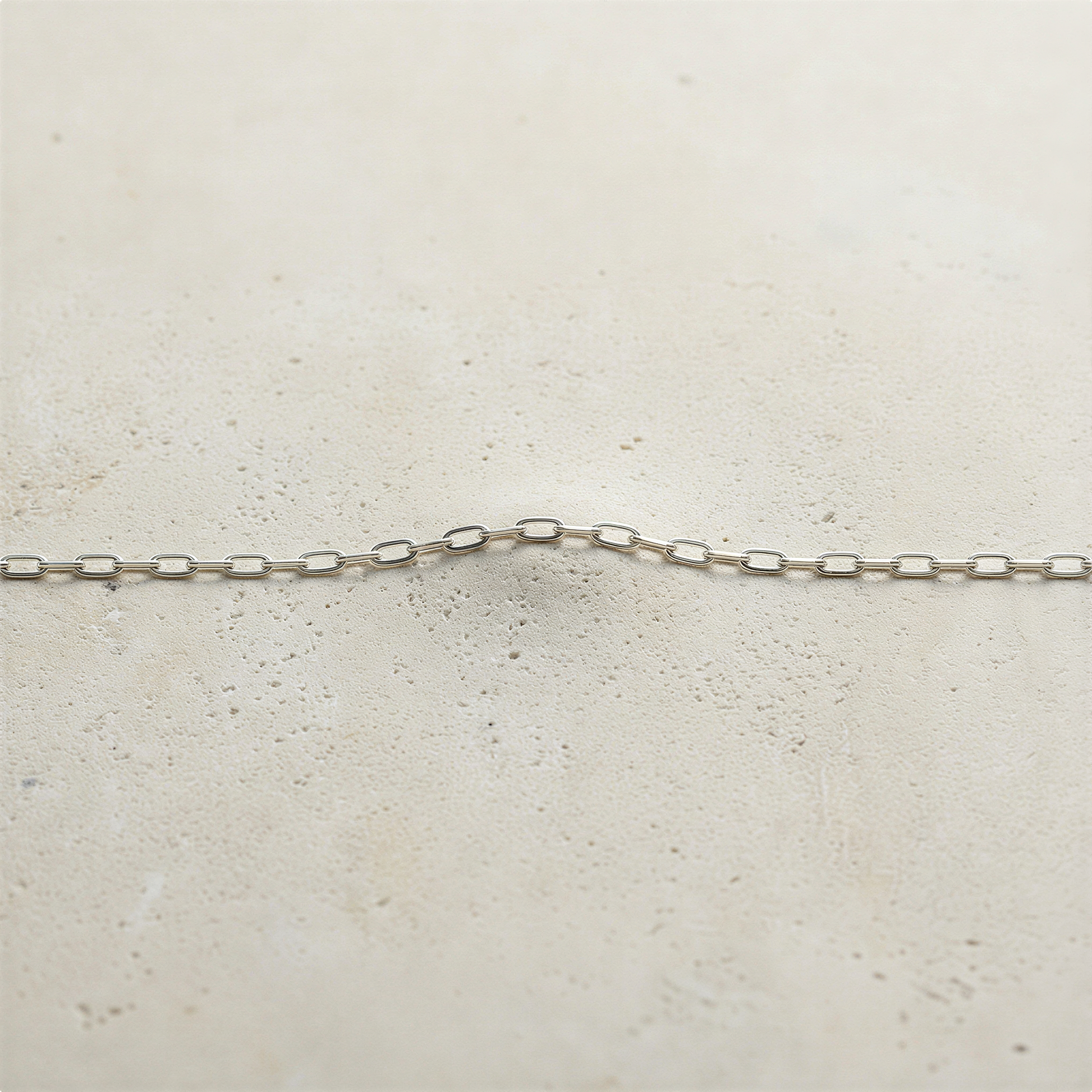 Sterling silver and gold filled cable chain styled with serene lighting, minimal backdrop, and effortless Neiman’s elegance