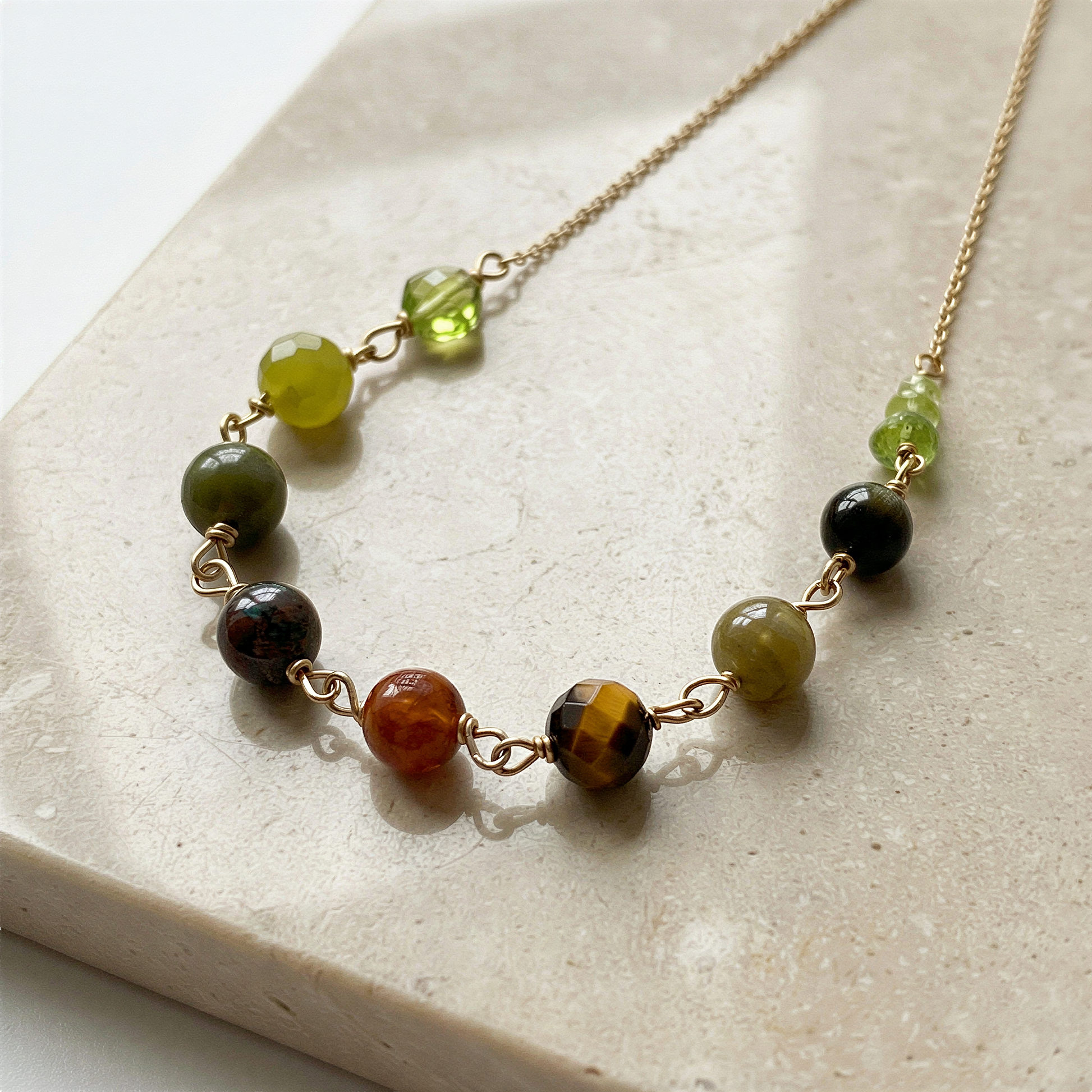 Year of the Snake necklace bead kit arranged elegantly, enhanced clarity and color on a refined neutral backdrop