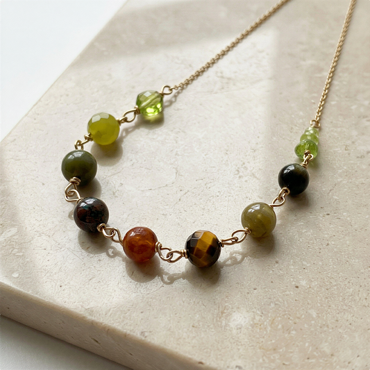Year of the Snake necklace bead kit arranged elegantly, enhanced clarity and color on a refined neutral backdrop