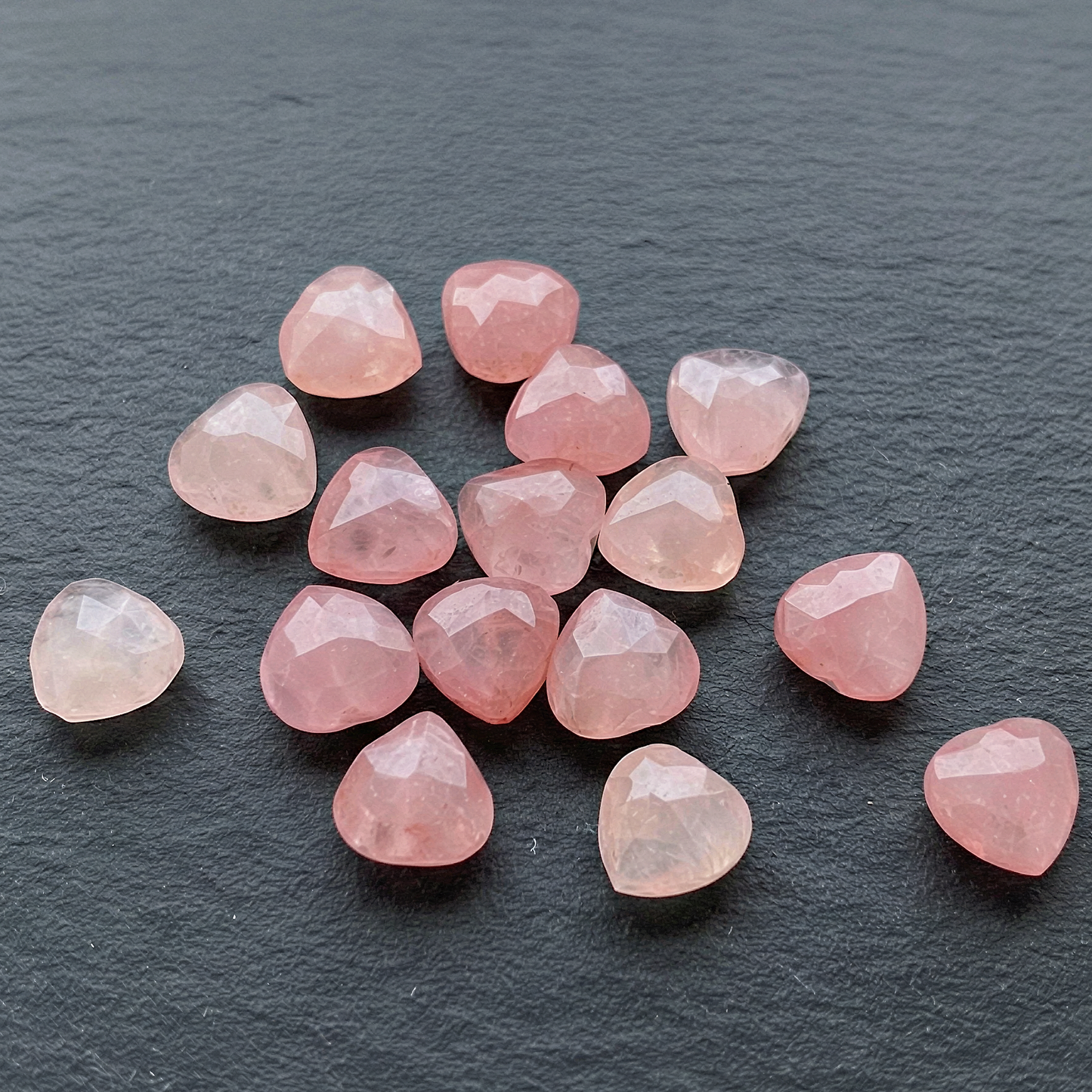 Faceted pink quartz heart bead softly enhanced for clarity, preserving natural color and refined, minimal presentation