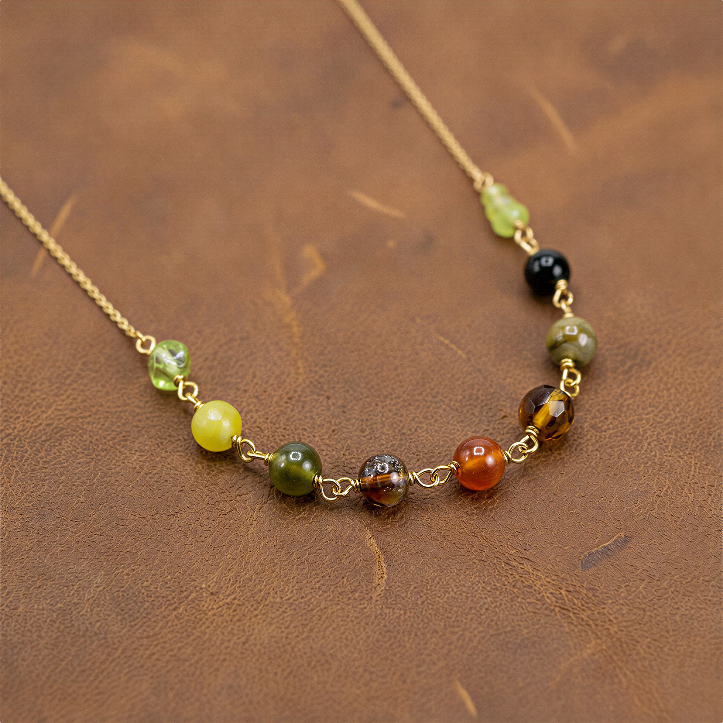 Jade-toned necklace beads arranged on linen surface with soft diffused light and calm, natural styling