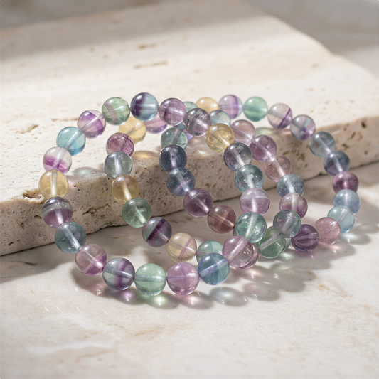 Rainbow fluorite stretchy bracelet with mixed bead sizes on neutral backdrop, refined clarity and gentle color enhancement
